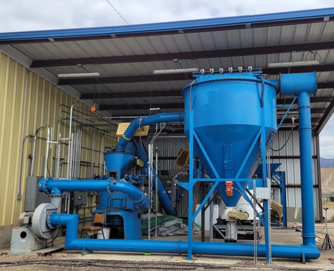 An outdoor ocean-blue colored pipe and reservoir system